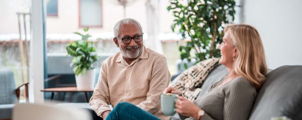 Man and woman talking on sofa