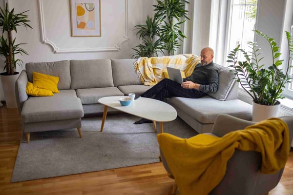 Man on sofa with laptop