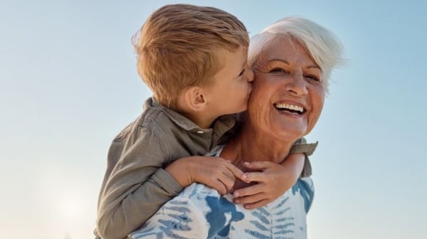 Grandmother smiling holding grandson