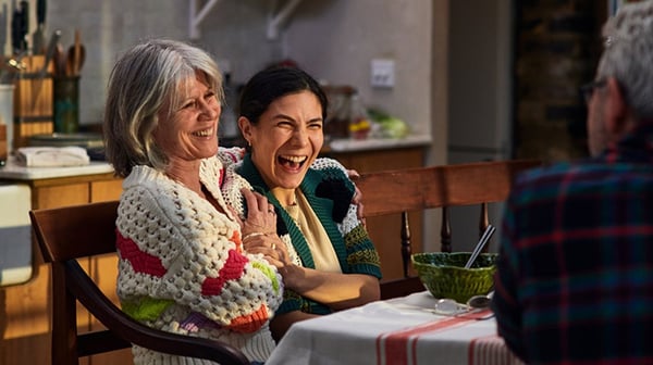 Women laughing on sofa