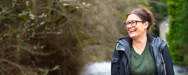 Lady by river laughing