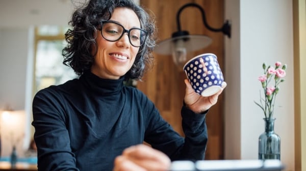 Smiling woman drinking coffee
