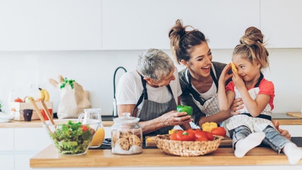 Three generations of women cooking in the kitchen