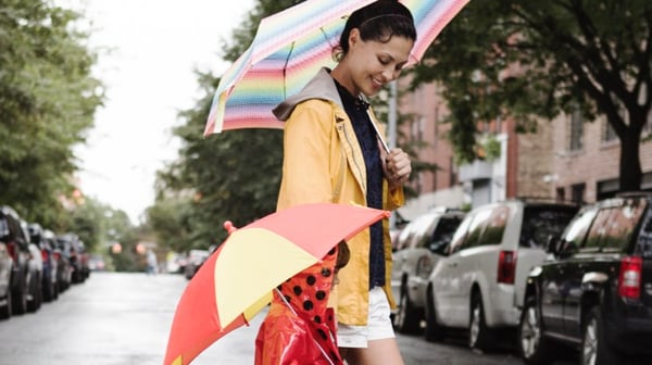 Woman with child walking under umbrella