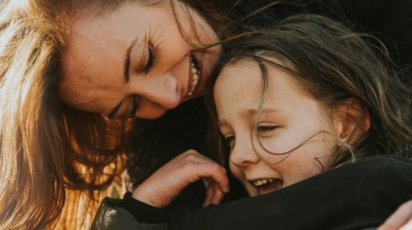 Woman cuddling child