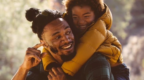 Child hugging man