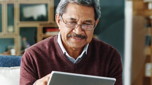 Man tapping at tablet