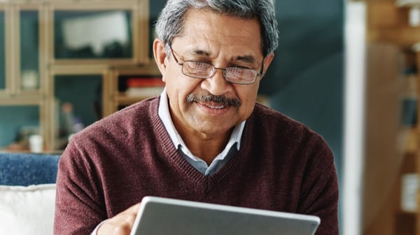 Man tapping at tablet