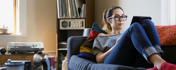 Woman relaxing on sofa with laptop