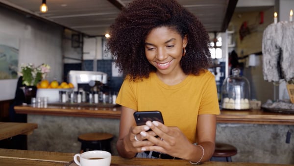 Smiling woman looking at phone app