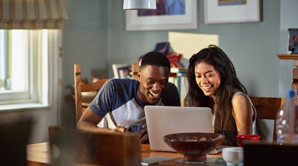 Couple staring at laptop