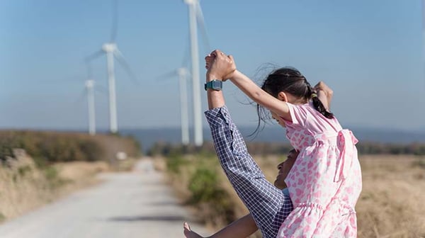 Father and daughter at a wind farm