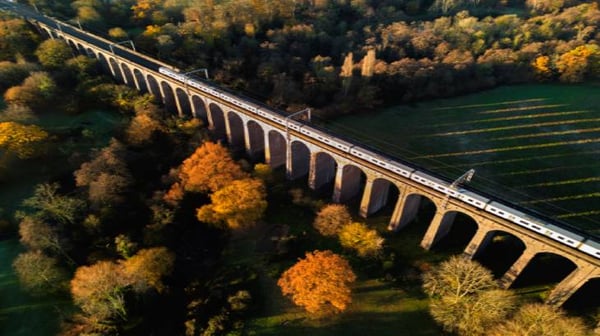 Train passing over a viaduct in the countryside