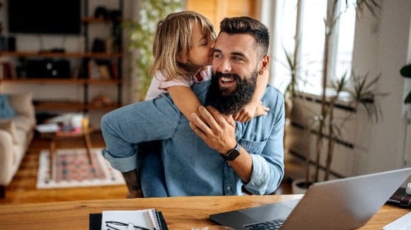Father and young daughter hugging