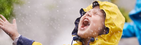 Little boy dancing in the rain