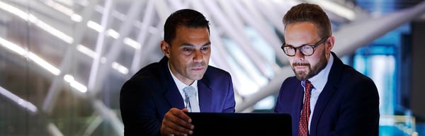 Two men on laptop