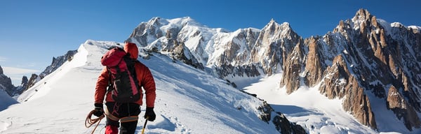 Mountaineer walking along a snow-capped ridge