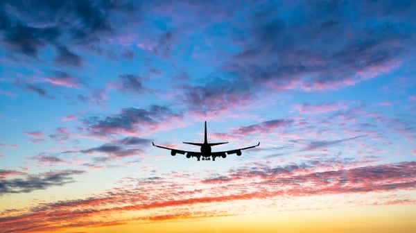 Image of am aeroplane flying at sunset