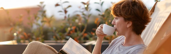 Woman looking relaxed drinking coffee outside