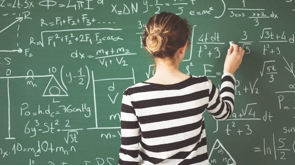 Women doing calculations on a chalk board