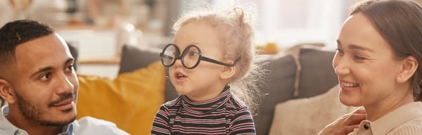 Mum and dad playing with young daughter