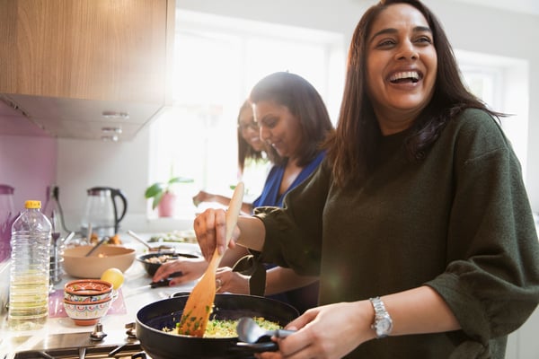 Family laughing and cooking