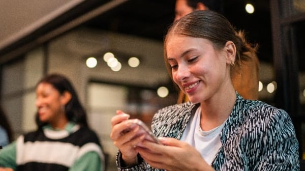 Young lady on her phone in cafe