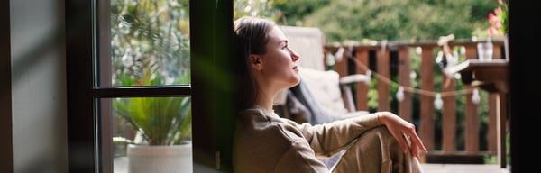 Woman looking out of window