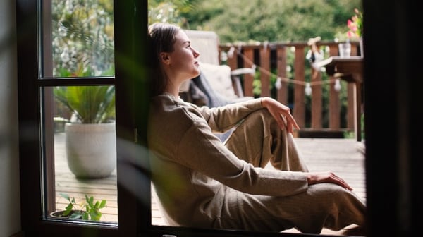 Woman looking out of window
