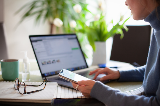 Woman using phone laptop