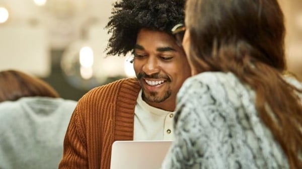 Man smiling at laptop