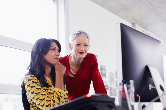 Businesswomen looking at computer
