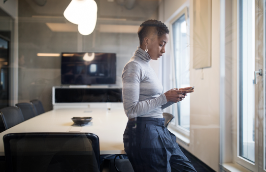 Businesswoman looking at mobile phone