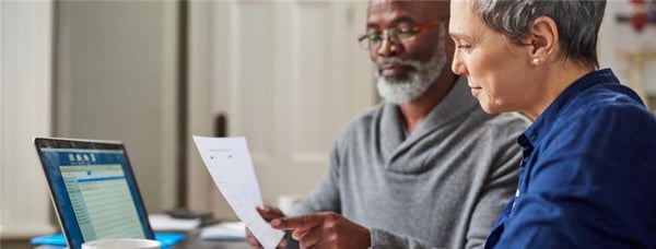An older couple reviewing paperwork together