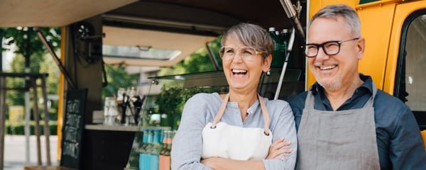Happy couple next to food truck