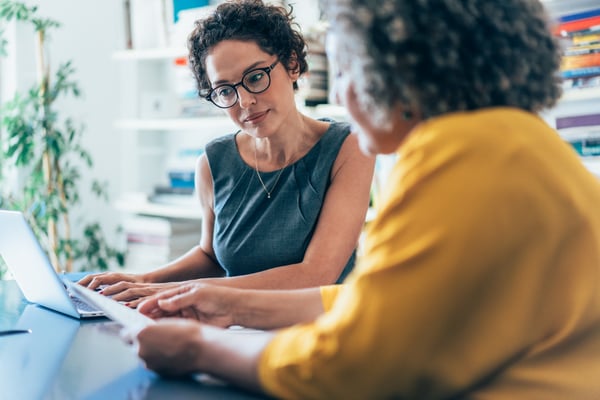 Couple looking over documents with laptop