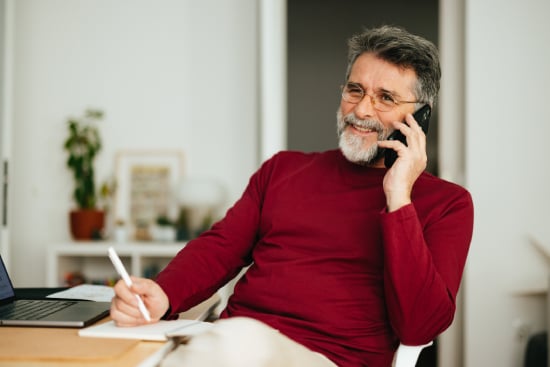 Smiling Mature Businessman Talking On A Mobile Phone