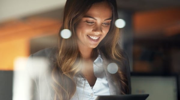 Woman smiling at tablet
