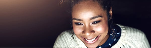 Woman smiling at laptop