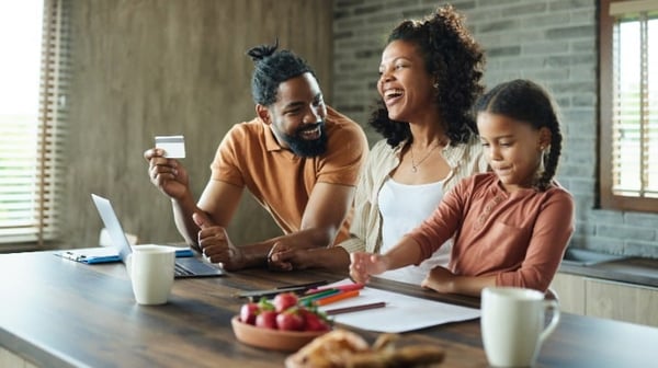 Image of family smiling together in the kitchen