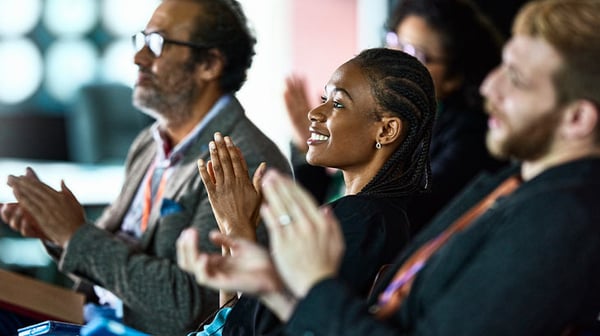 People listening at a meeting