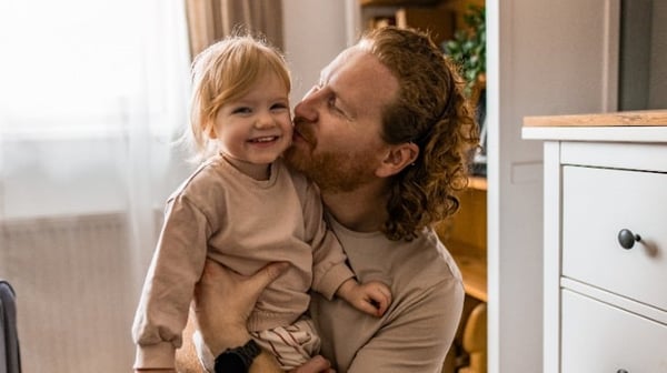 Father hugging toddler daughter