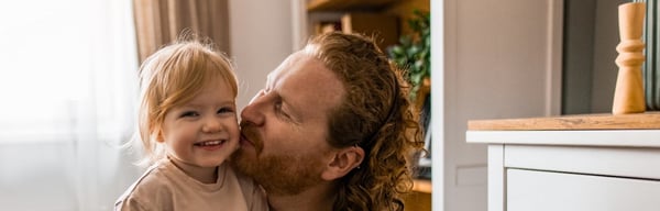 Father hugging toddler daughter
