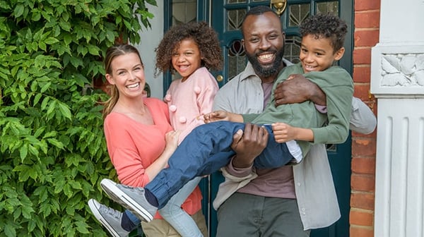 Family standing in their door