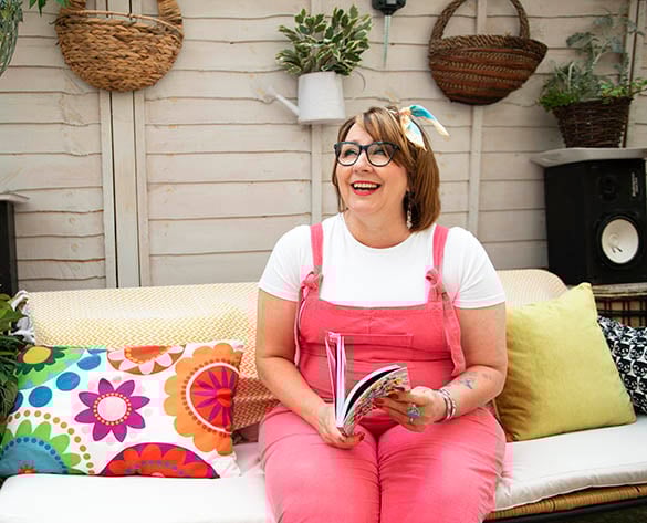 Smiling woman on outdoor sofa