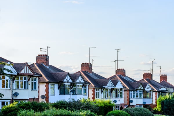 Rooftops of semi detached houses, with chimneys and aerials