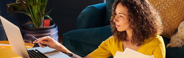 Woman sitting in living room working on her finances