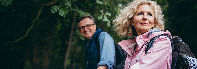 Older couple walking in woods