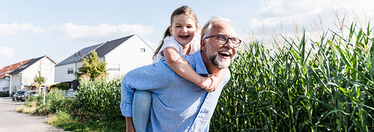 Adult carrying child walking outdoors