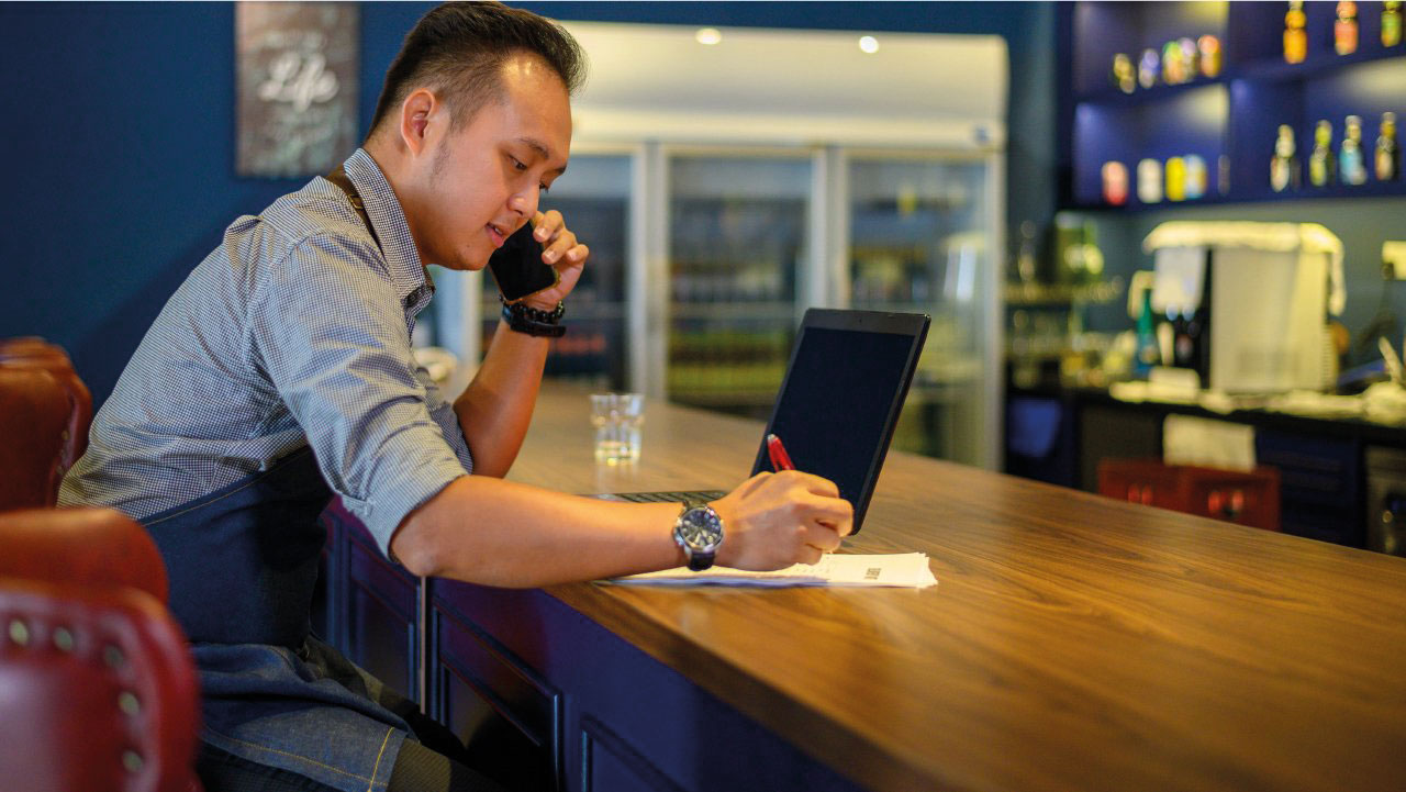 Man with laptop at bar